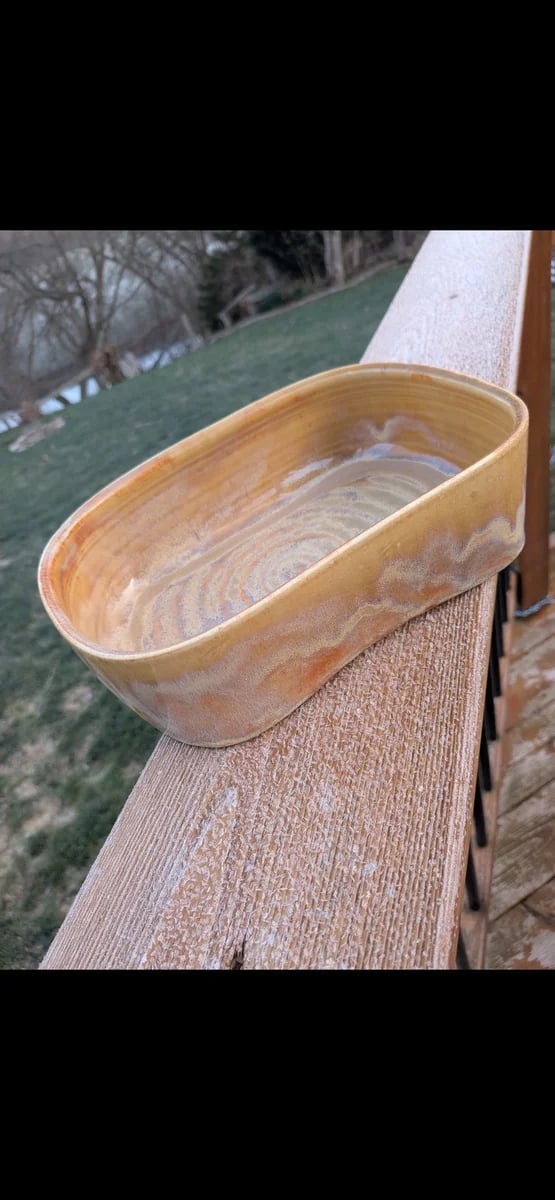 A hand-built honey and amber oval dish